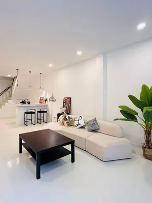 a white living room with a couch and a table at Fivehouse Silom2 soi11 City heart Silom BTS 7min in Bang Rak