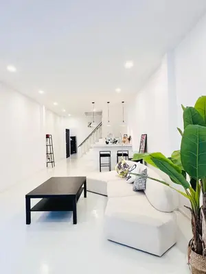 a white living room with a white couch and a table at Fivehouse Silom2 soi11 City heart Silom BTS 7min in Bang Rak