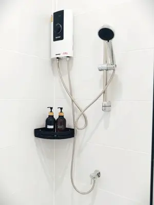 a shower with a hose attached to a wall at Fivehouse Silom2 soi11 City heart Silom BTS 7min in Bang Rak