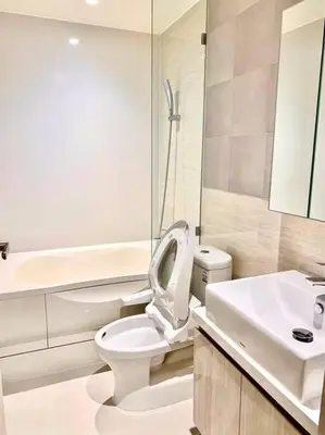 a white bathroom with a toilet and a sink at BTS Thonglor - Serene Japanese-style Haven, Onsen in Bangkok