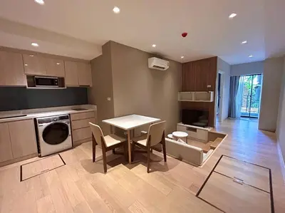 a kitchen with a table and chairs in a room at BTS Thonglor - Serene Japanese-style Haven, Onsen in Bangkok