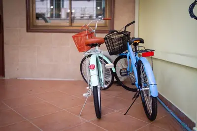 two bikes are parked next to a wall at Asokes Hidden Gem Cozy Stay Next to the Park in Bangkok