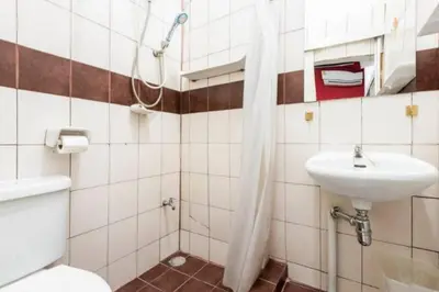 a bathroom with a toilet and a sink at 1137 Hostel in Bangkok