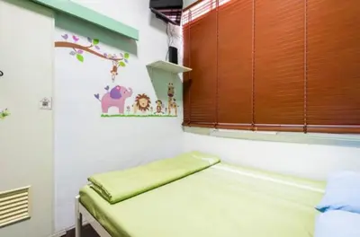a small room with a bed and a window at 1137 Hostel in Bangkok