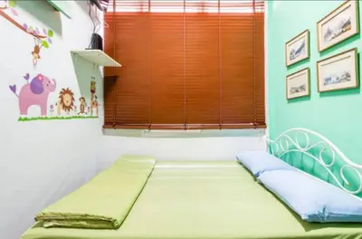 a bed in a room with a window at 1137 Hostel in Bangkok