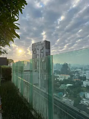 a glass balcony with a view of a city at Thong Lor, Sukhumvit 36 in Bangkok