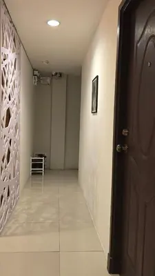 a room with a hallway with a door and a tile floor at The Haven Sabi in Bangkok