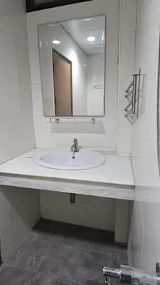 a bathroom with a sink and a mirror at The Haven Sabi in Bangkok