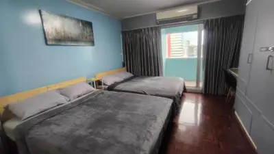 a room with two beds and a window at Silom room 40 sqm with 2 Queen beds for 4 persons in Bangkok