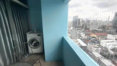 a washing machine in a room with a window at Silom room 40 sqm with 2 Queen beds for 4 persons in Bangkok