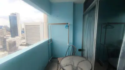 a blue room with a chair and a window at Silom room 40 sqm with 2 Queen beds for 4 persons in Bangkok
