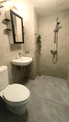 a bathroom with a toilet and a sink and a shower at Silom room 40 sqm with 2 Queen beds for 4 persons in Bangkok