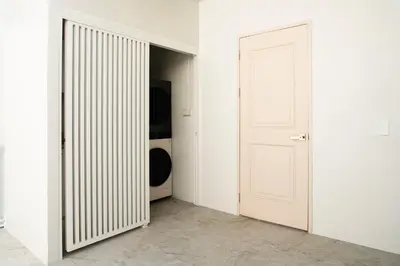 a white door in a room with a closet at Naiya Bangkok in Bangkok