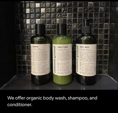 a group of three bottles of soap on a shelf at Cozy Apartment With Train Access in Bangkok