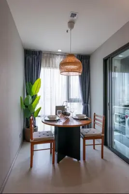a dining room with a table and two chairs and a dining room at Cozy Apartment With Train Access in Bangkok