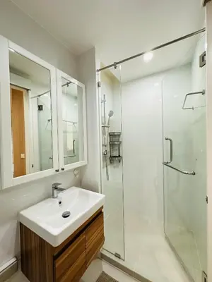 a bathroom with a sink and a glass shower at 6th Avenue Sukhumvit BKK 308 BTS Asoke & Nana MRT Sukhumvit in Bang Kapi