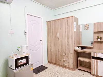 a kitchen with a white door and wooden cabinets at 811-STP Homely room Free Wi-Fi and Near BTS Line in Bangkok