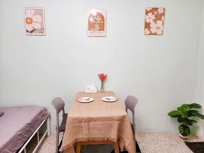 a table with two chairs and a table with plates on it at 811-STP Homely room Free Wi-Fi and Near BTS Line in Bangkok