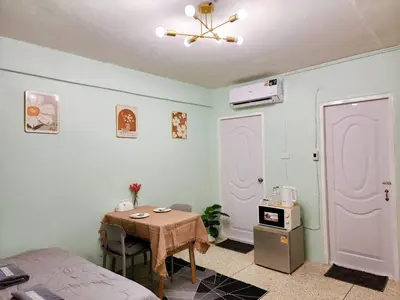 a room with a table and a bed and a room with a table at 811-STP Homely room Free Wi-Fi and Near BTS Line in Bangkok