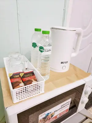a shelf in a refrigerator with a cup and water bottles at 811-STP Homely room Free Wi-Fi and Near BTS Line in Bangkok