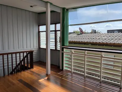 a balcony of a building with a large window at Green Cabin Hostel in Bangkok