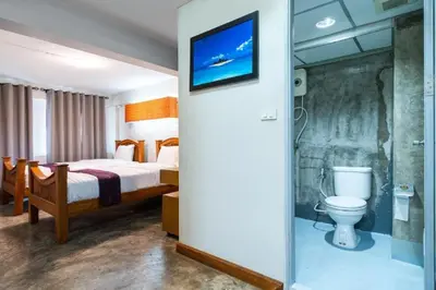 a hotel room with a bed and a toilet at XX GO INN Khaosan - The Grand Palace ตรอกข้าวสาร in Bangkok