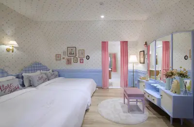 a bedroom with a large white bed and a mirror at Kitsch Hotel in Bangkok