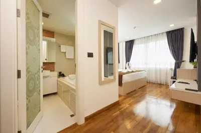 a bathroom with a sink and a toilet in a room at Shine Aparthotels Sukhumvit Thonglor in Bangkok