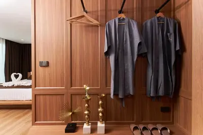 a room with a closet with jackets and shoes at Shine Aparthotels Sukhumvit Thonglor in Bangkok