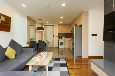 a living room with a couch and a table at Shine Aparthotels Sukhumvit Thonglor in Bangkok