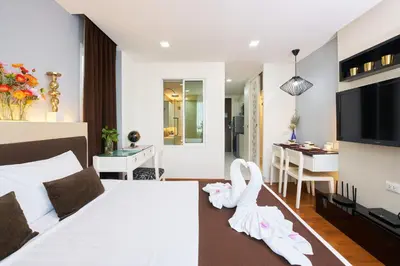 a hotel room with a bed and a dining room at Shine Aparthotels Sukhumvit Thonglor in Bangkok