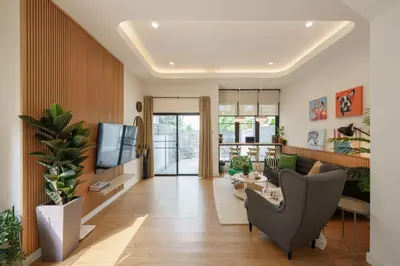 a living room with a couch and a tv at Cozy Spacious 4BR Villa, 12pax, 200m BTS PhraKhanong, 10min ThongLo, Fast 500mbps Wifi in Bangkok