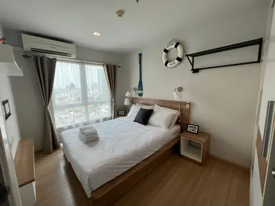 a bedroom with a bed and a large window at Cozy Living in Bangkok 60m to MRT near chatuchank in Bang Su