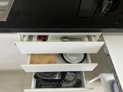 a kitchen cabinet with white shelves and a microwave at Cozy Living in Bangkok 60m to MRT near chatuchank in Bang Su