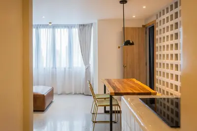 a kitchen with a desk and a table in a room at PETRA Designer Apartment Sukhumvit, Nana BTS in Bangkok
