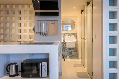 a kitchen with a counter top with a microwave at PETRA Designer Apartment Sukhumvit, Nana BTS in Bangkok