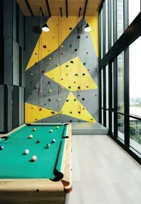 a pool table in a room with a rock wall at \ub77c\uc2fc\ucf58\ub3c4 in Bangna