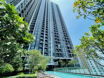 a tall building with a pool in front of it at \ub77c\uc2fc\ucf58\ub3c4 in Bangna