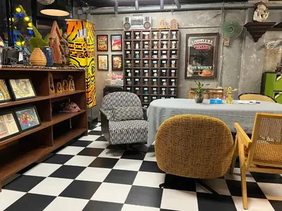 a table and chairs in a room with a checkered floor at Years 1981 in Bangkok