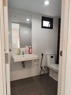 a bathroom with a sink and a toilet at Baan Salaya in Salaya