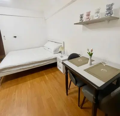 a bedroom with a bed and a table with chairs at Apartment studio at platinum in Bangkok