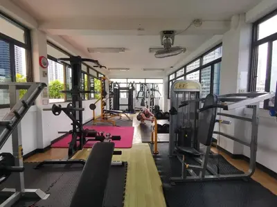 a gym with several treadmills and exercise equipment at Apartment studio at platinum in Bangkok