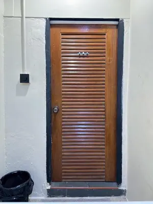 a wooden door on the side of a building at Chubbi5 room11 in Bangkok