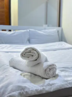 a towel sitting on top of a bed at Chubbi5 room11 in Bangkok