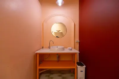 a bathroom with a sink and a mirror at Siam Twin Charoenkrung in Bangkok