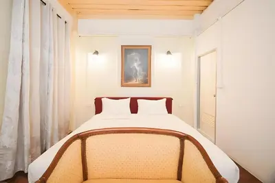 a bedroom with a large bed in a room at XX Mitr Inn Yaowarat - China Town in Bangkok