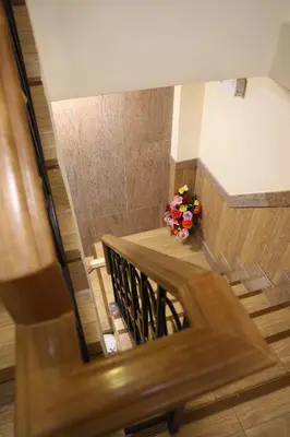 a view of a staircase with a vase of flowers at Tanee Place in Bangkok