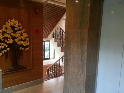 a hallway with a tree mural on the wall at Tanee Place in Bangkok