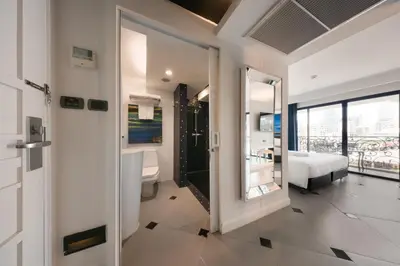 a bathroom with a toilet and a sink at Skye Hotel Bangkok in Bangkok