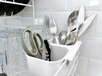 a white container filled with utensils on a counter at Komfy Quarters in Sathani Bang Khen